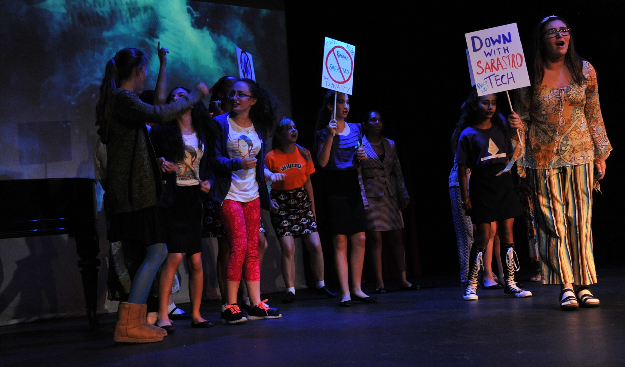 students protesting with signs that say "Down with Sarastro Tech"