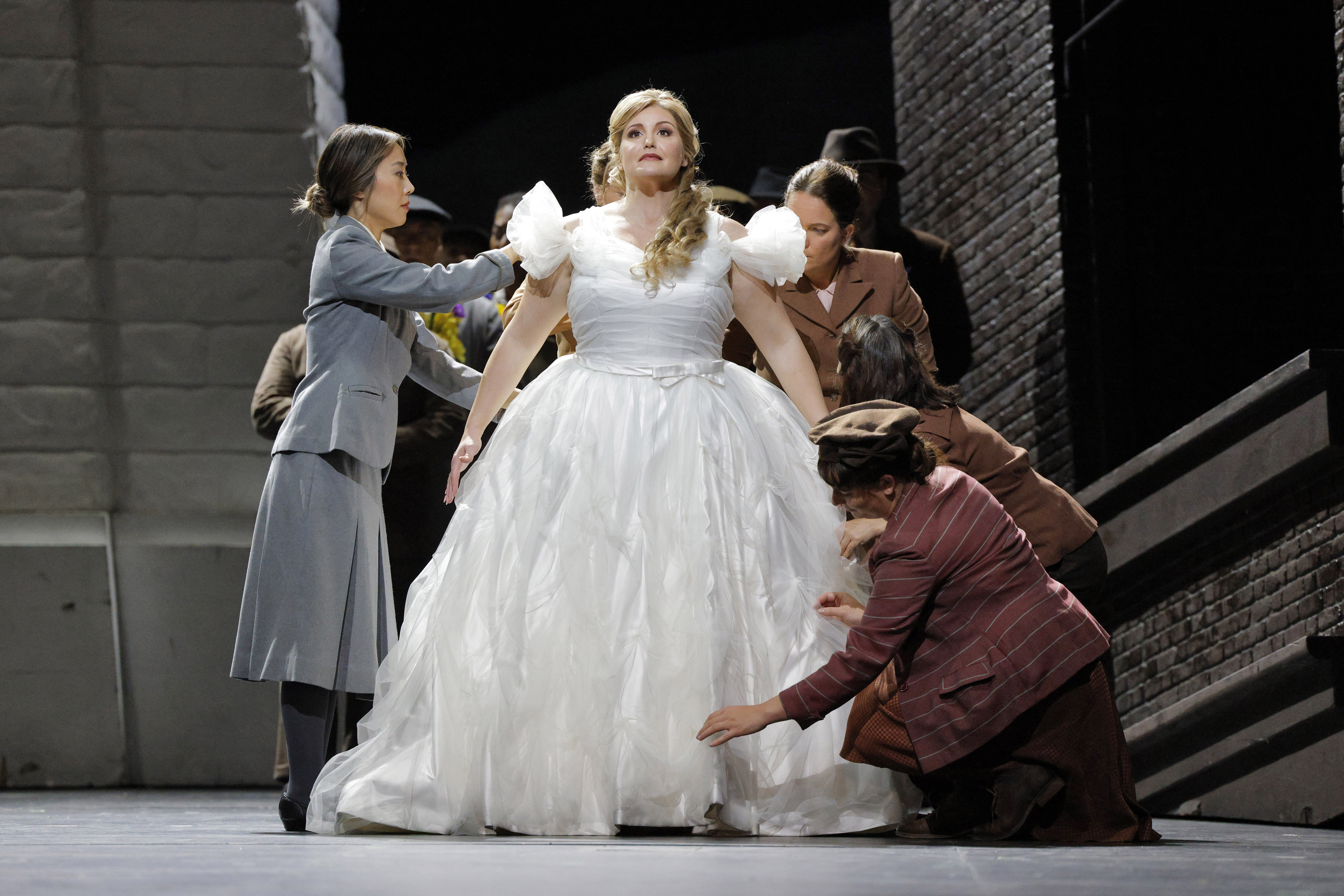women attending to a woman in a wedding dress